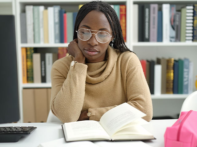 Student studying notes in library