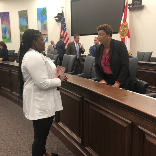 Student pharmacist conversed with Senator Tracie Davis (Jacksonville - District 5).